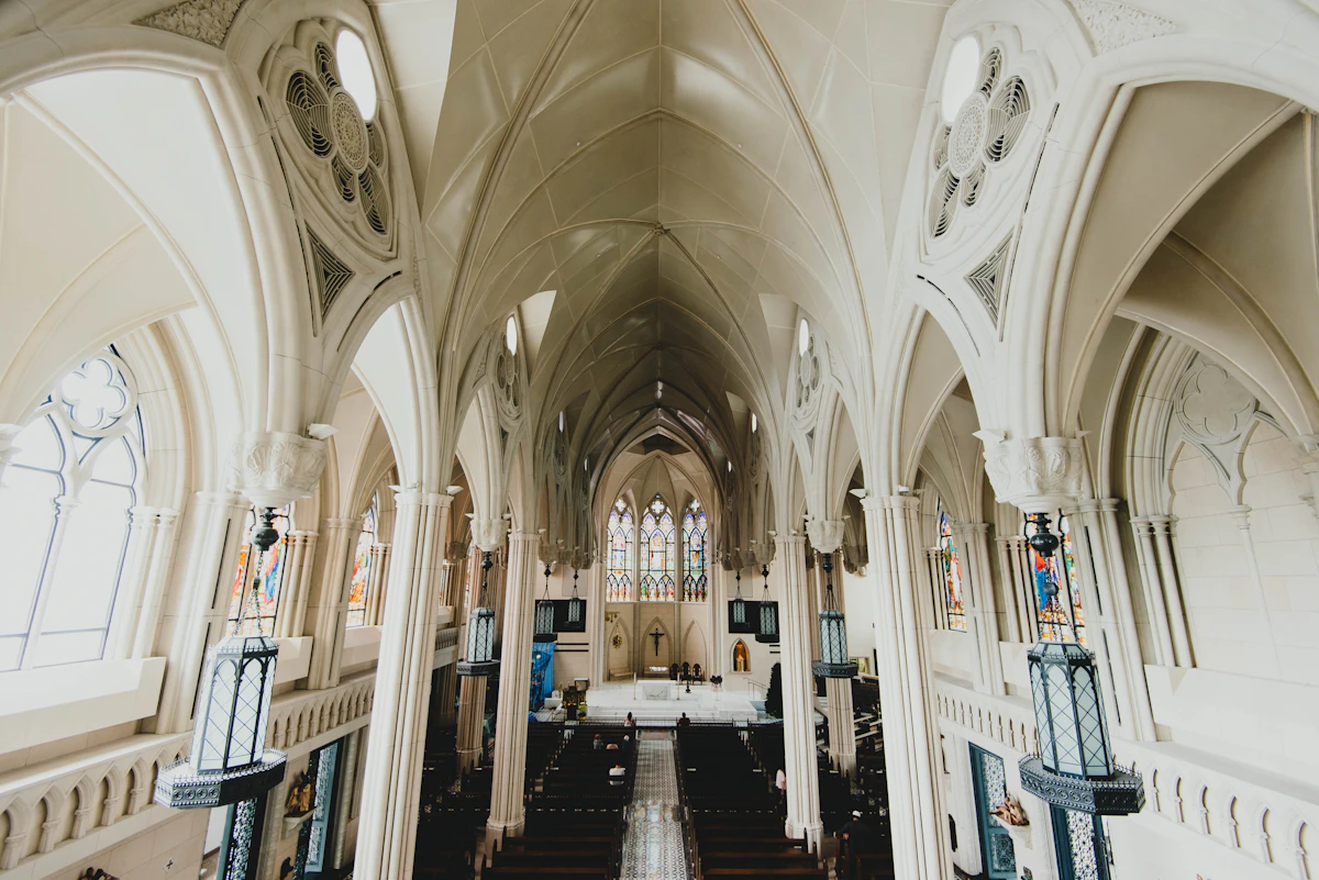 Church nave with pews and a vaulted ceiling