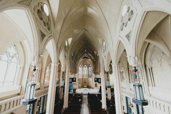 Church nave with pews and a vaulted ceiling