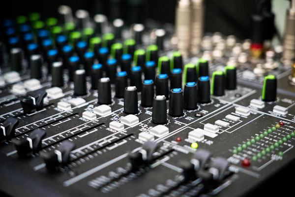 Audio mixing console with faders and channel controls